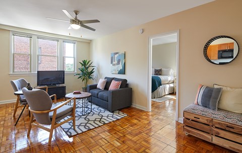 a living room with a couch and a chair and a tv