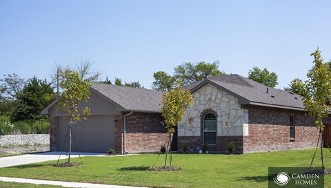 A house with a garage and a green door is shown.