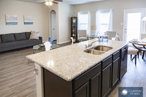 A kitchen with a granite countertop and a sink.
