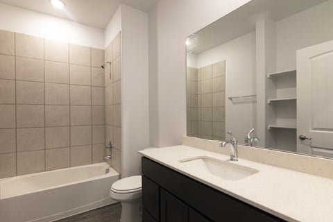 A bathroom with a white sink and a white toilet.