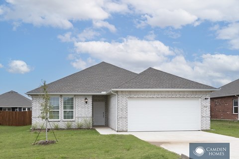 A house with a Camden Homes sign in the front yard.