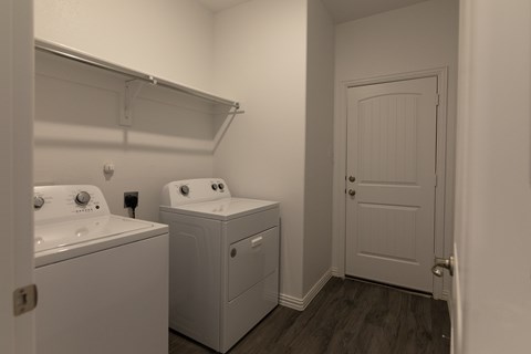 A small bathroom with a washer and dryer.