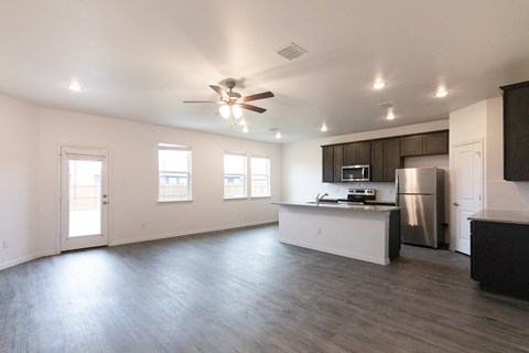 A spacious kitchen with a refrigerator, microwave, and oven.