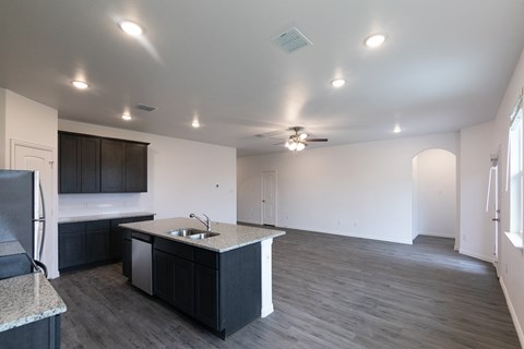A kitchen with a sink and a refrigerator.