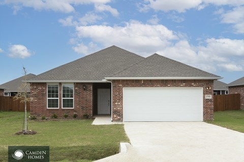 A house with a garage door that says 8211 on it.