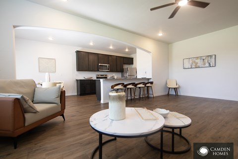 A living room with a couch, chairs, and a coffee table.