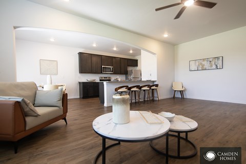 A living room with a couch, chairs, and a coffee table.