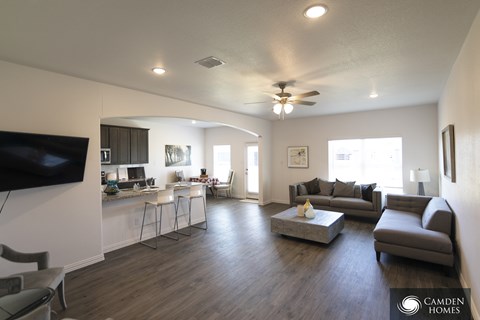 A living room with a television on the wall and a couch.