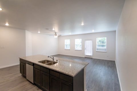 A kitchen with a sink and cabinets.