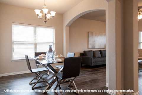 A dining room with a glass table and chairs.