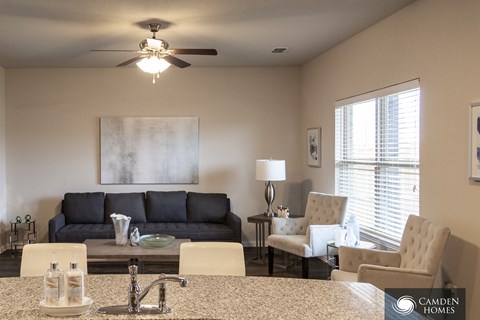 A Camden Homes model home with a kitchen island and furniture.