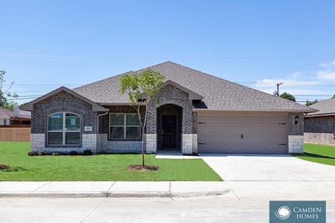 A house with a Camden Homes sign in front.