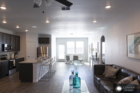 A modern kitchen with dark wood cabinets and a white island.