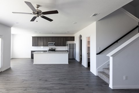 A modern kitchen with a fan on the ceiling.