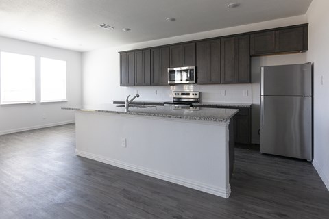 A kitchen with a white countertop and a refrigerator.