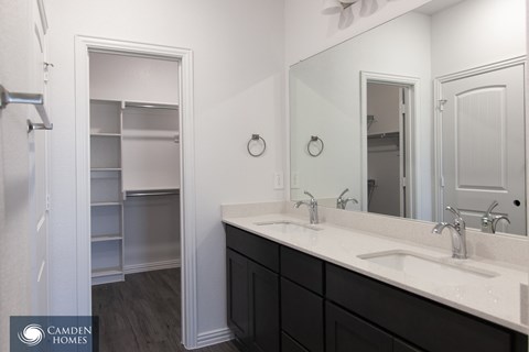 A bathroom with a sink, mirror, and medicine cabinet.