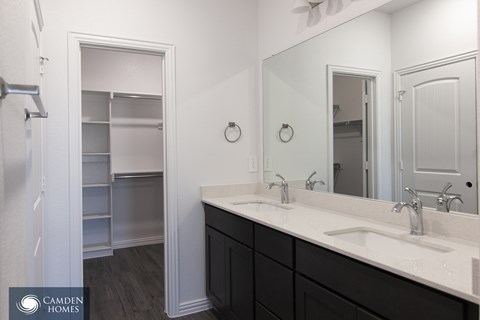 A bathroom with a sink, mirror, and medicine cabinet.