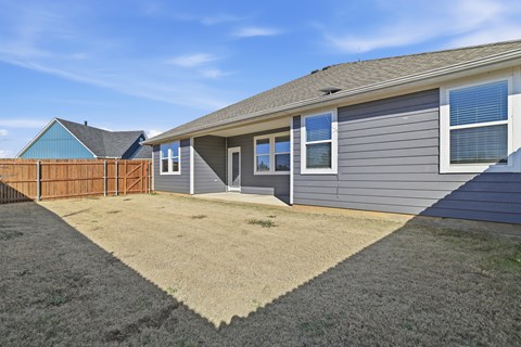A house with a grey exterior and a brown fence.