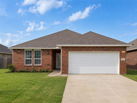 A house with a white garage door and a brick facade.
