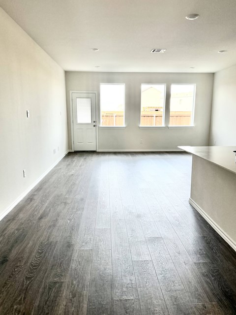 A room with a wooden floor and a white door.