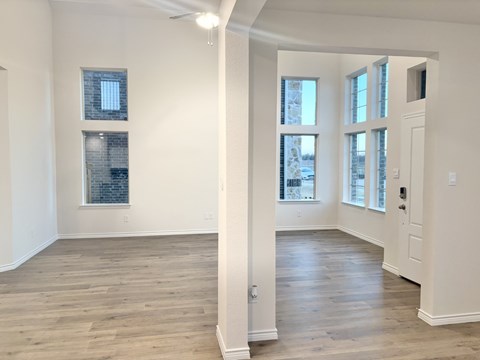 A room with wooden floors and white walls.