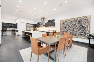 A modern dining room with a large table and chairs.