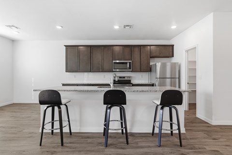 A kitchen with a white countertop and brown cabinets.