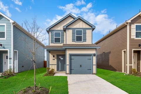 A house with a grey garage door is in the foreground.