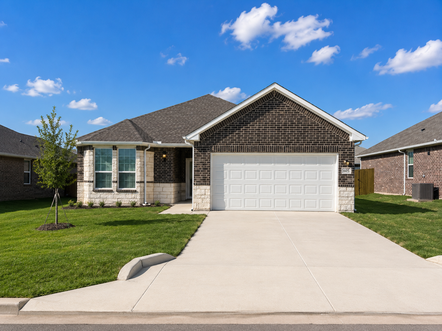 A house with a white garage door is shown.