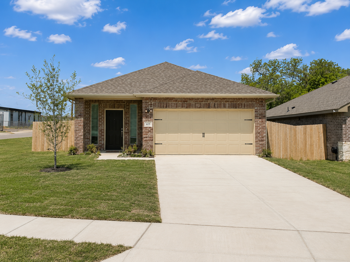 A house with a brown roof and a garage door.