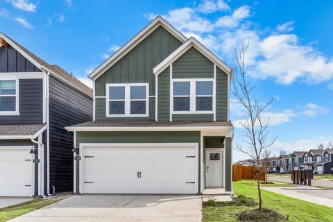 A two-story house with a garage is shown in the image.