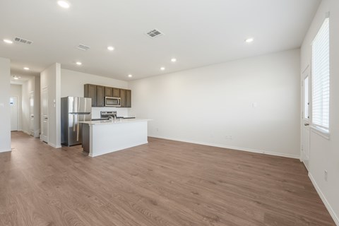 A kitchen area with a refrigerator, microwave, and oven.