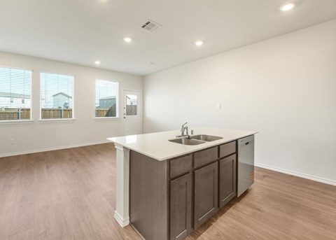 A kitchen with a sink and cabinets.