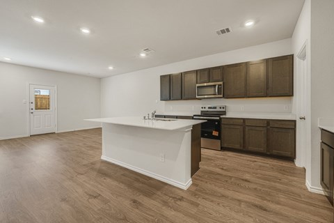 A kitchen with brown cabinets and a white countertop.