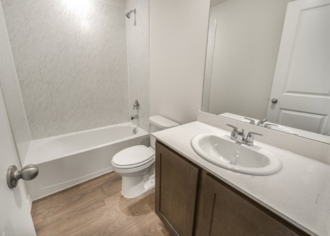 A white toilet sits next to a sink in a bathroom.