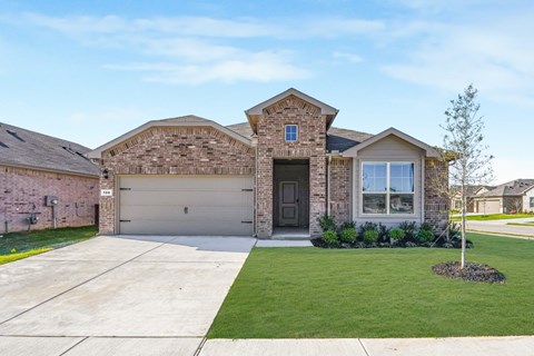 A house with a brick facade and a large driveway.