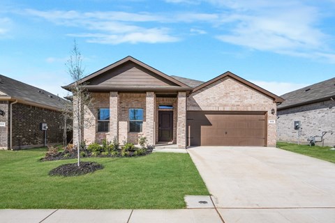 A house with a brown garage door and a brown roof.