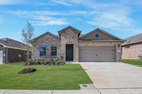 A house with a grey roof and a black garage door.