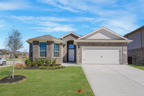 A house with a white garage door and a grey roof.