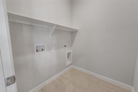 A white wall with a few pictures and a white door.