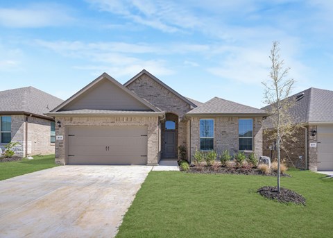 A house with a garage and a driveway in front.