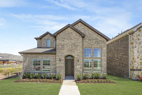 A house with a brown brick exterior and a black front door.