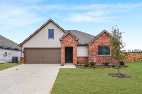 A house with a brown garage door and a brick chimney.