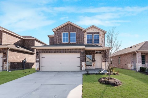 A house with a garage and a driveway in front.