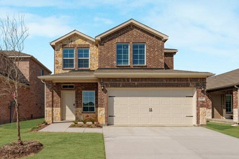 A two-story house with a garage and a driveway.