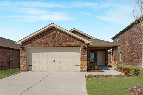 A house with a garage door and a driveway.