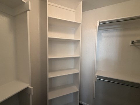 Empty white shelves in a room.