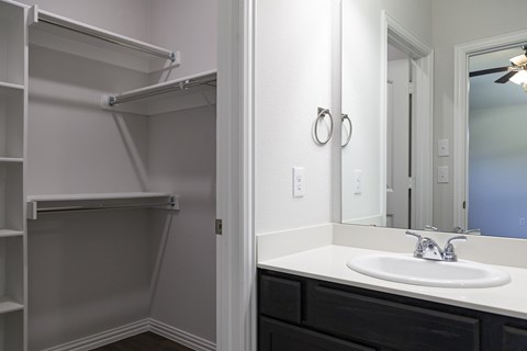 A bathroom with a white sink and a mirror.
