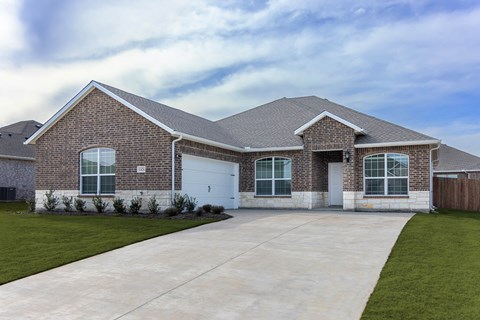 A house with a grey roof and a white garage door.