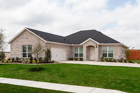 A house with a grey roof and a white garage door.